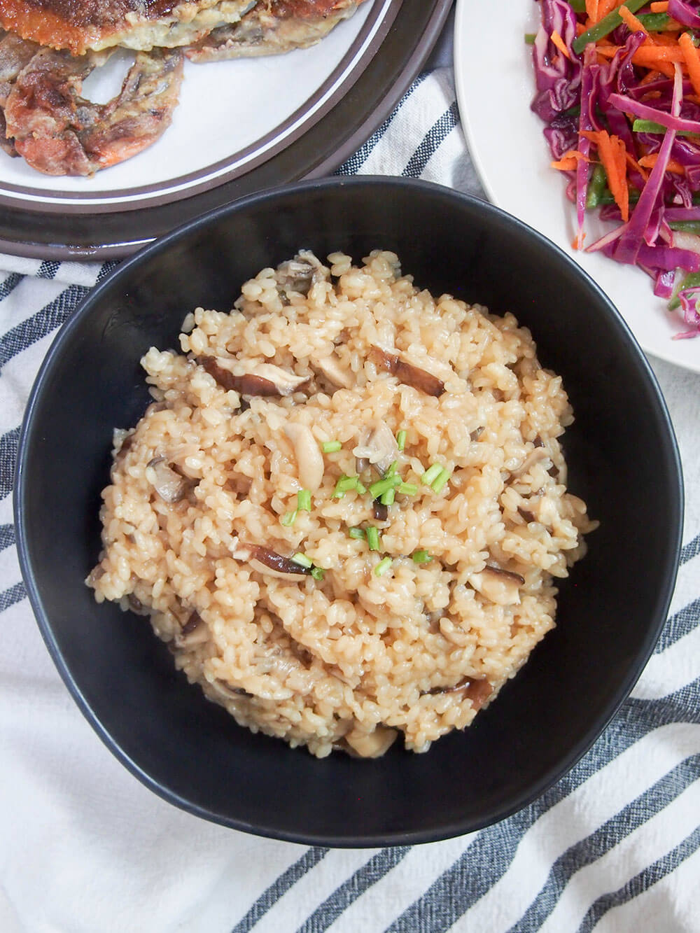 Japanese mushroom rice (kinoko gohan) bowl from overhead with other dishes next to it