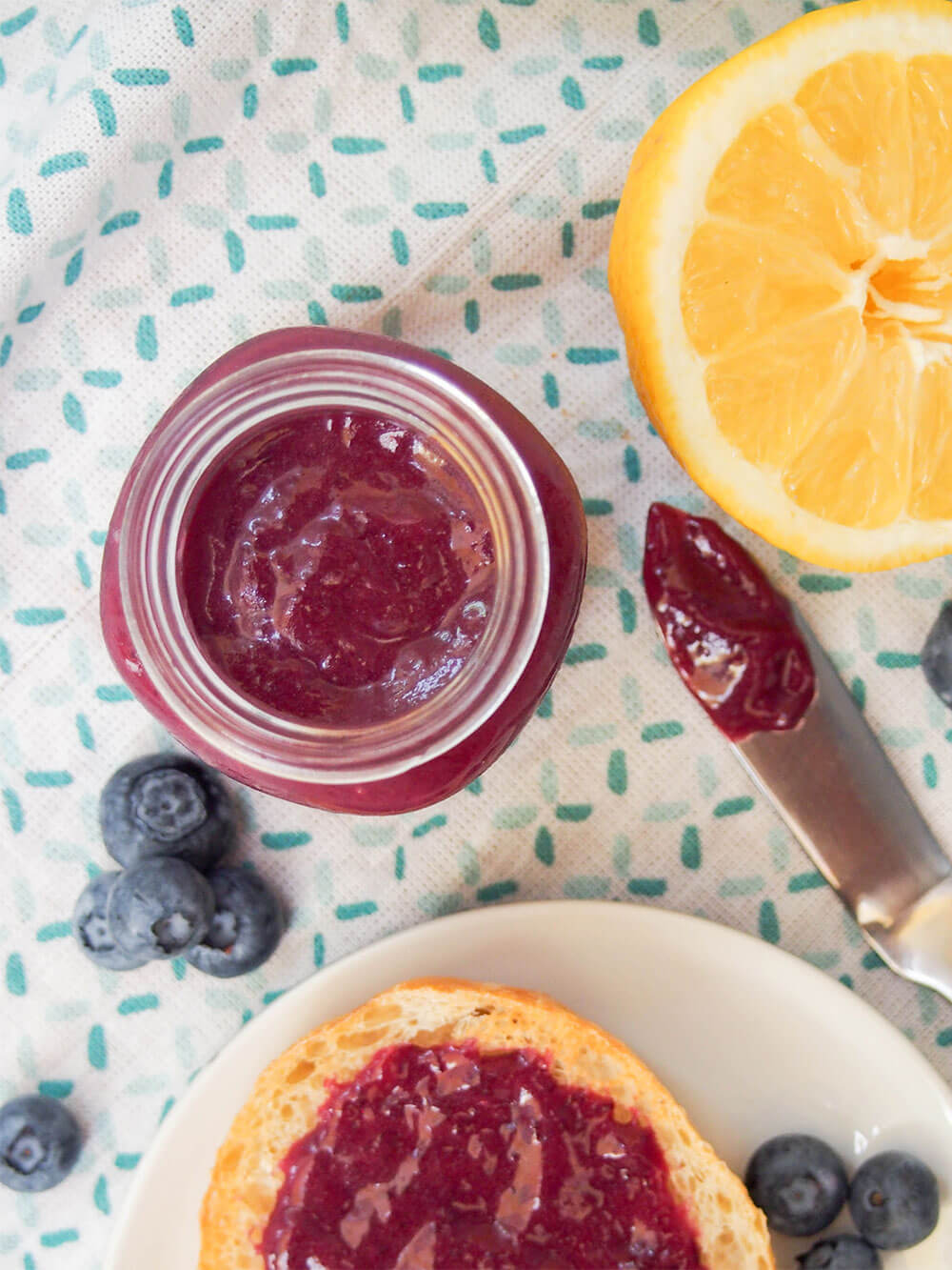 blueberry curd in jar with knife to side