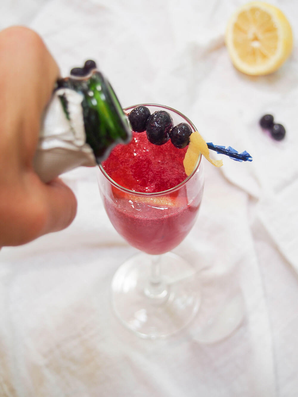 adding champagne to cocktail