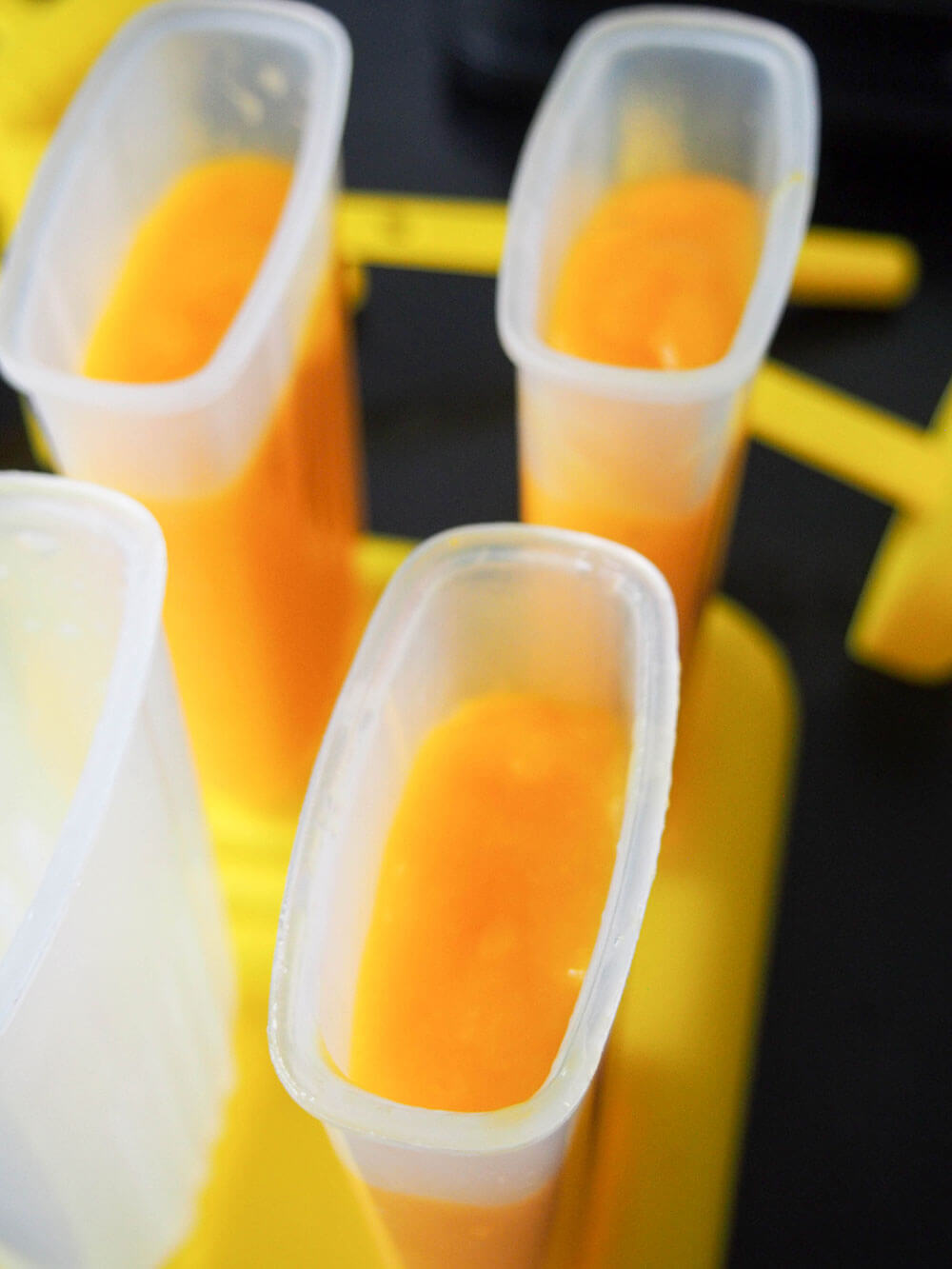 filling popsicle mould with mango palatas (ice pops) mixture