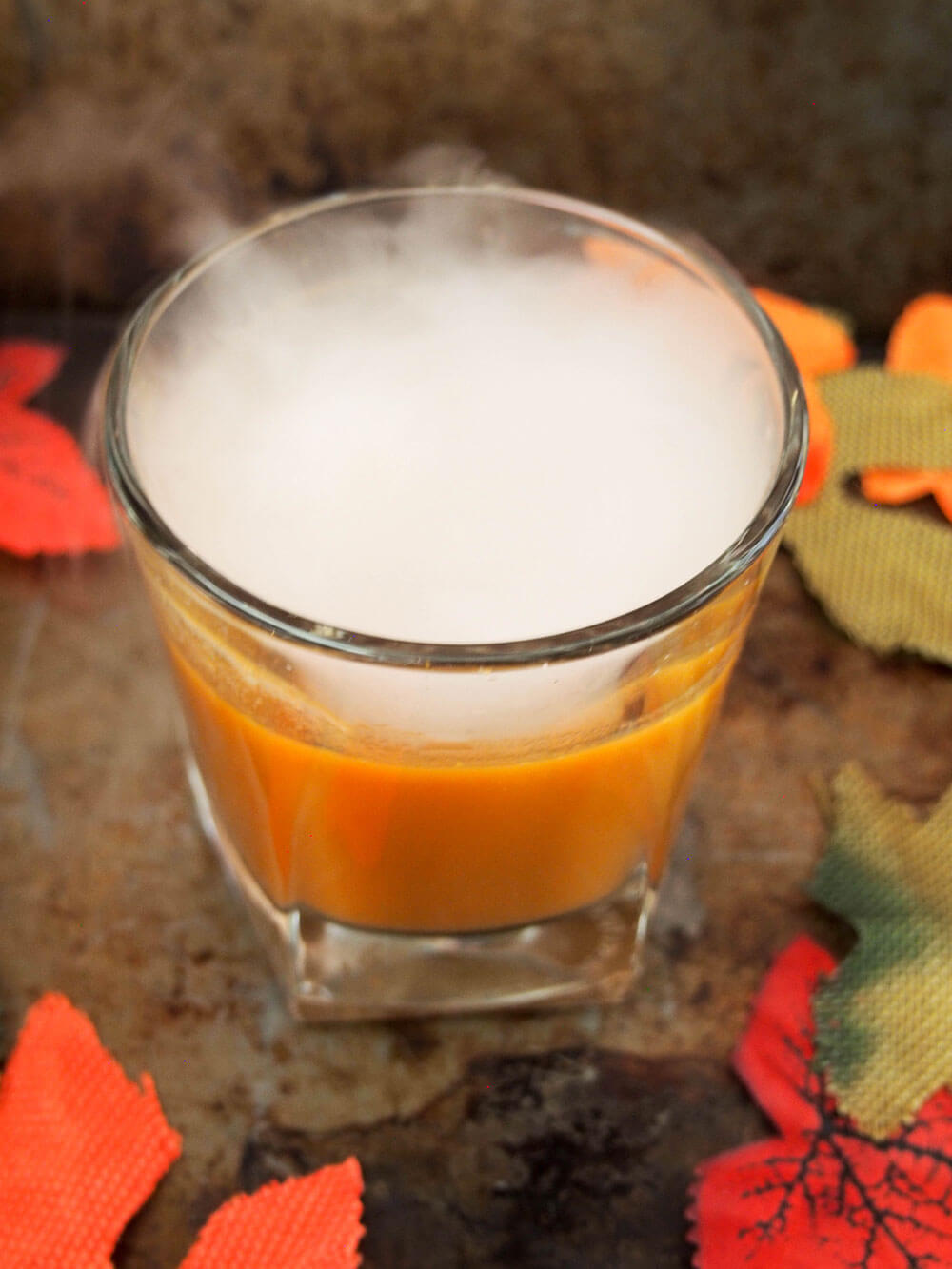 falling for orange: amaro pumpkin cocktail with dry ice flowing