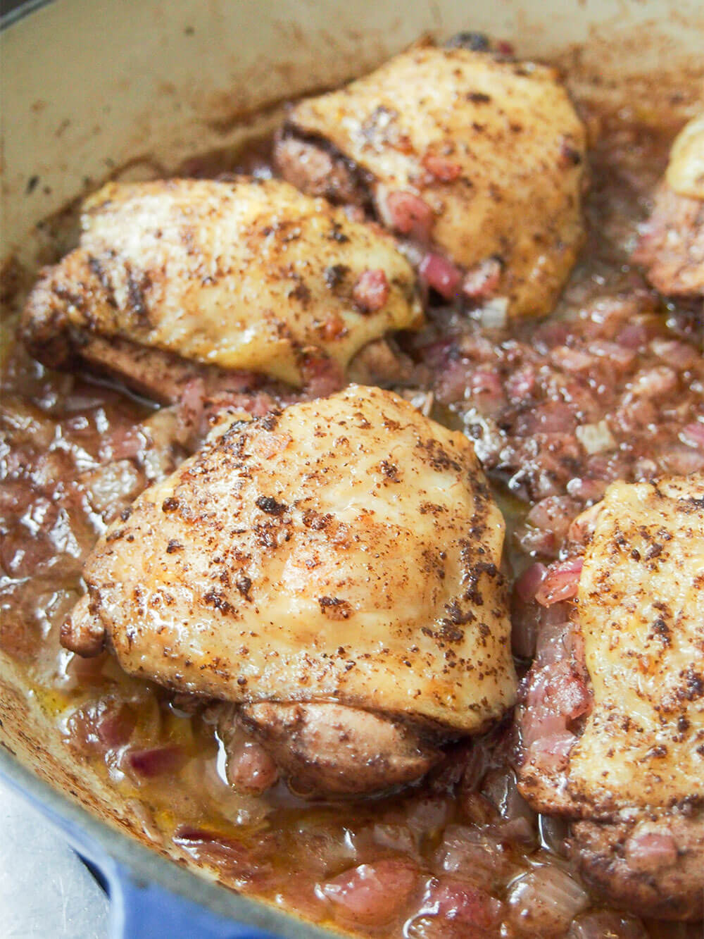 Cooked chicken and onions in pan on coming out the oven