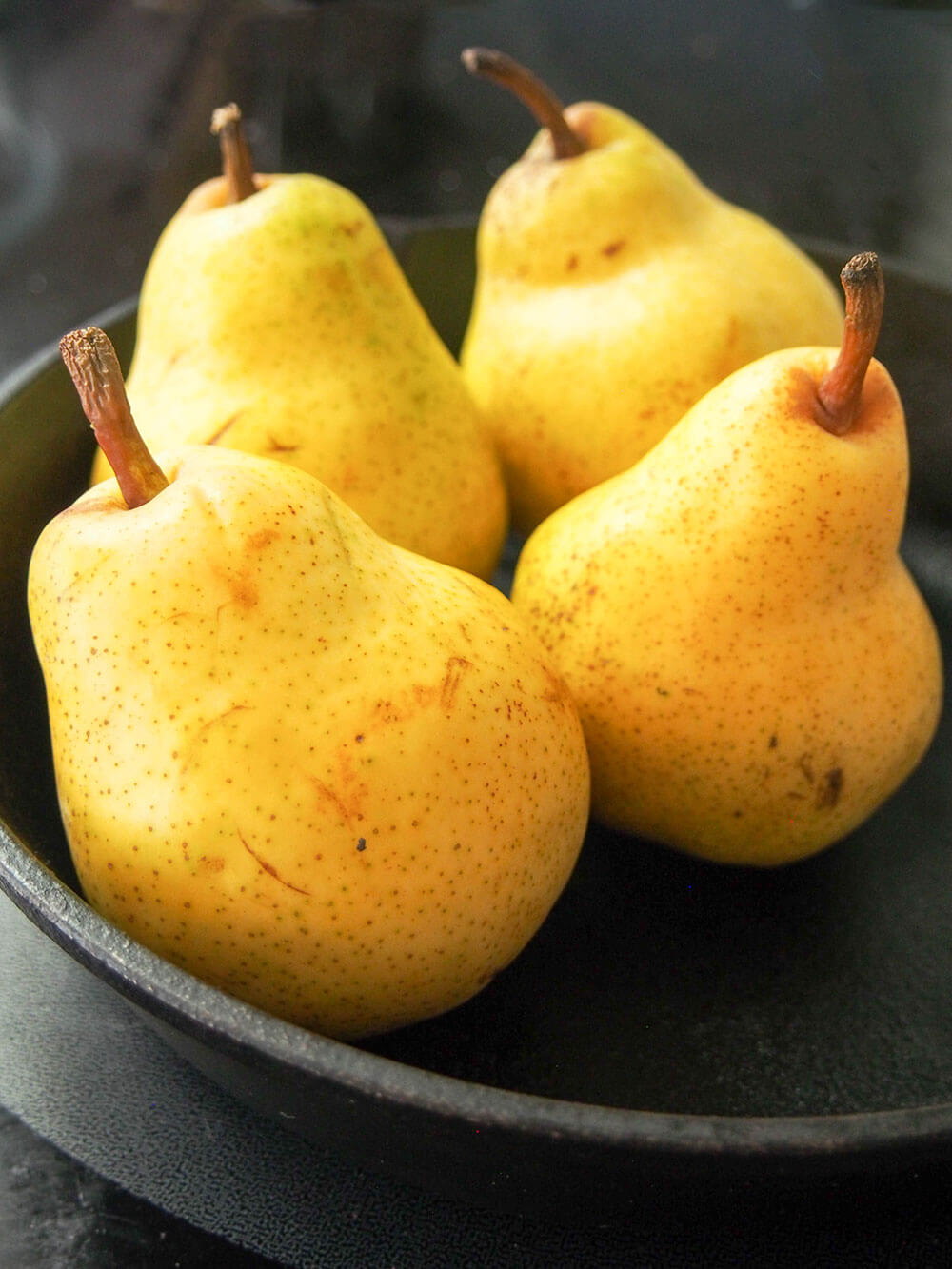 whole pears sitting in skillet