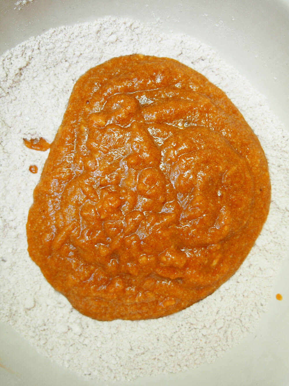 adding wet ingredients to dry ingredients