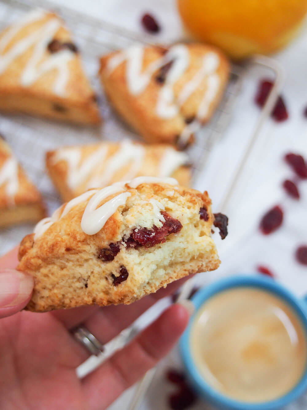 holding scone with bite taken from it