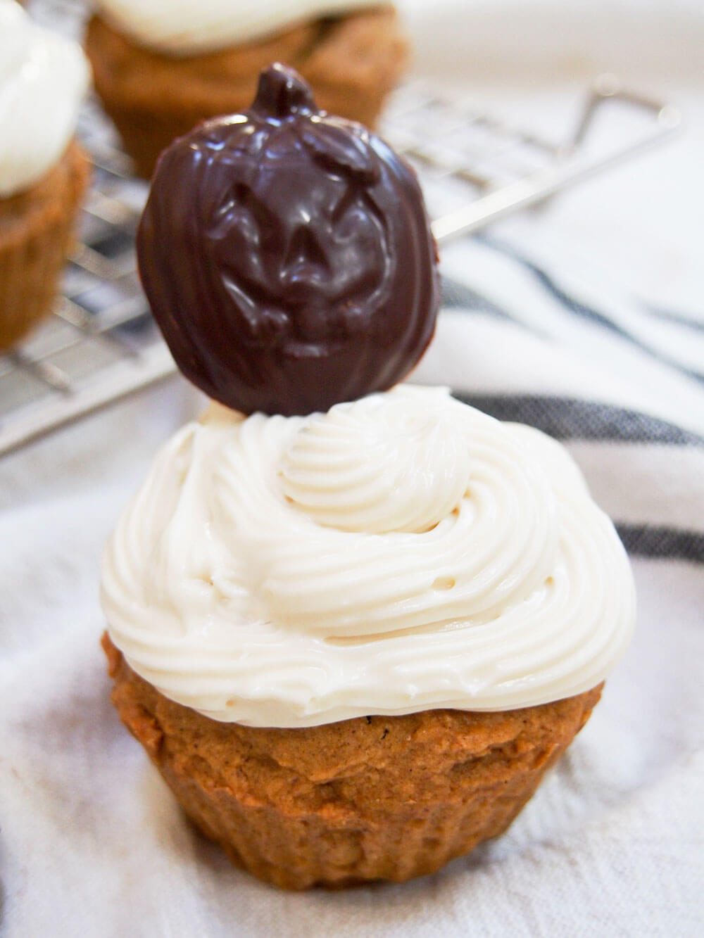 Pumpkin cupcake close up with chocolate pumpkin on top