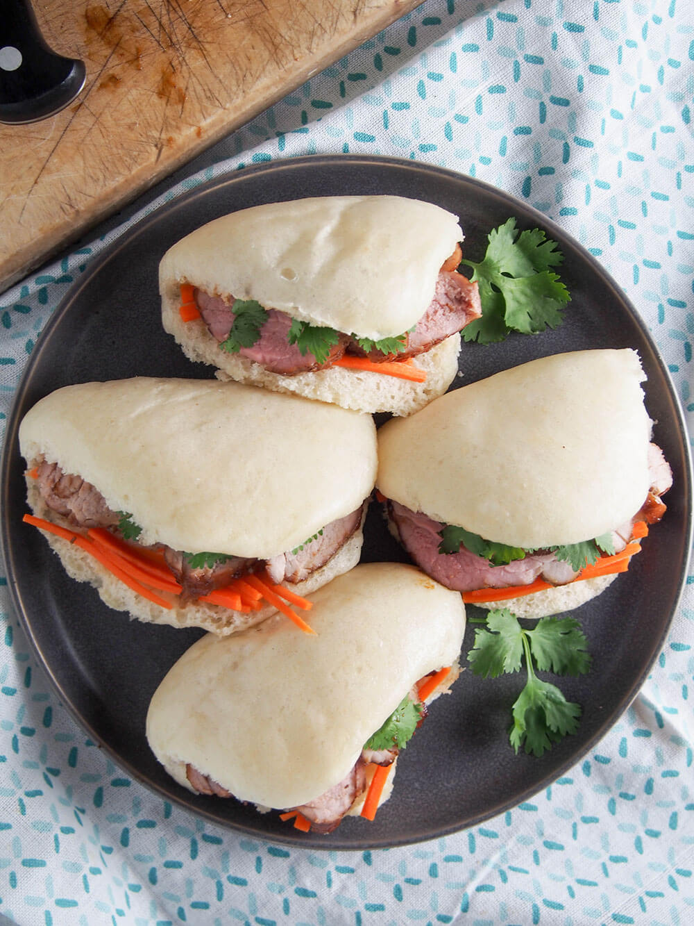 steamed bao buns with pork on plate
