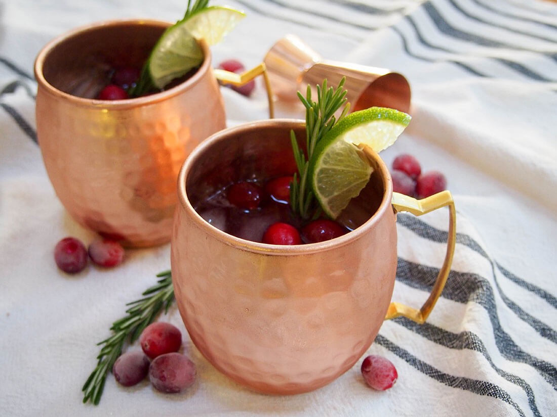 This cranberry Moscow mule is a simple seasonal twist on a classic cocktail, that can also easily be made as a mocktail. cranberry Moscow mules in copper mugs