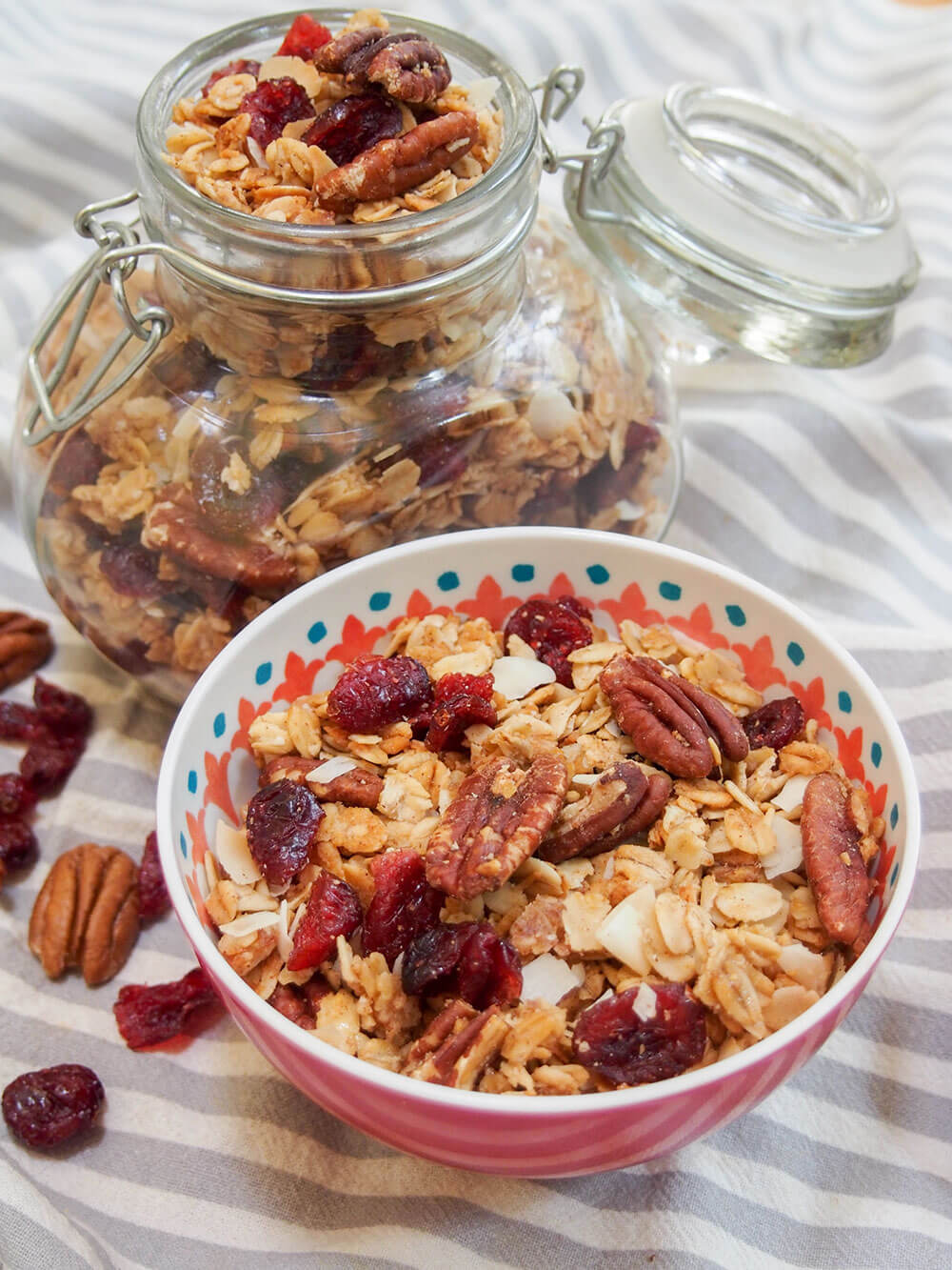 homemade granola with bowl to front and jar behind