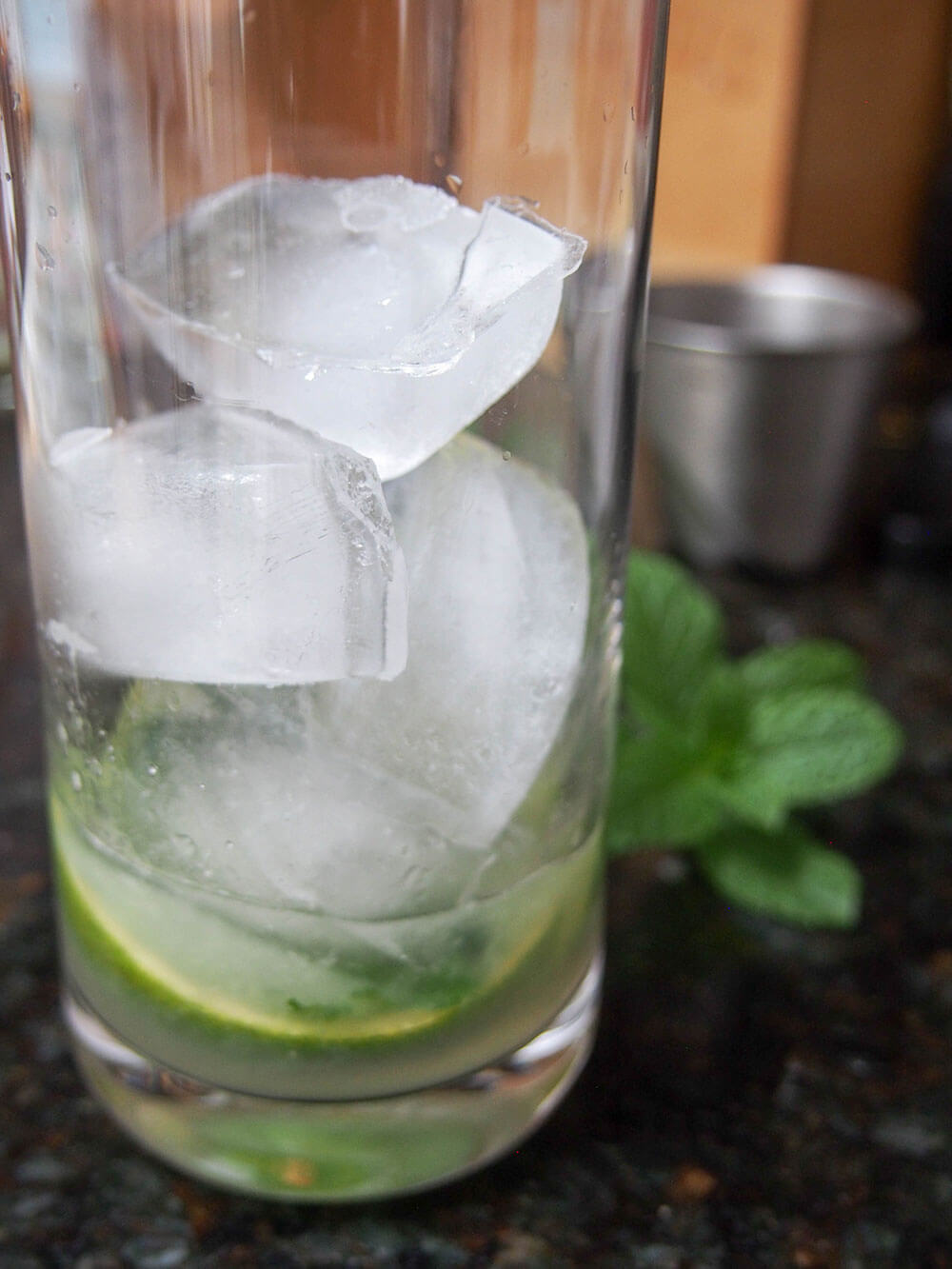 rum, lime and mint in glass with ice on top
