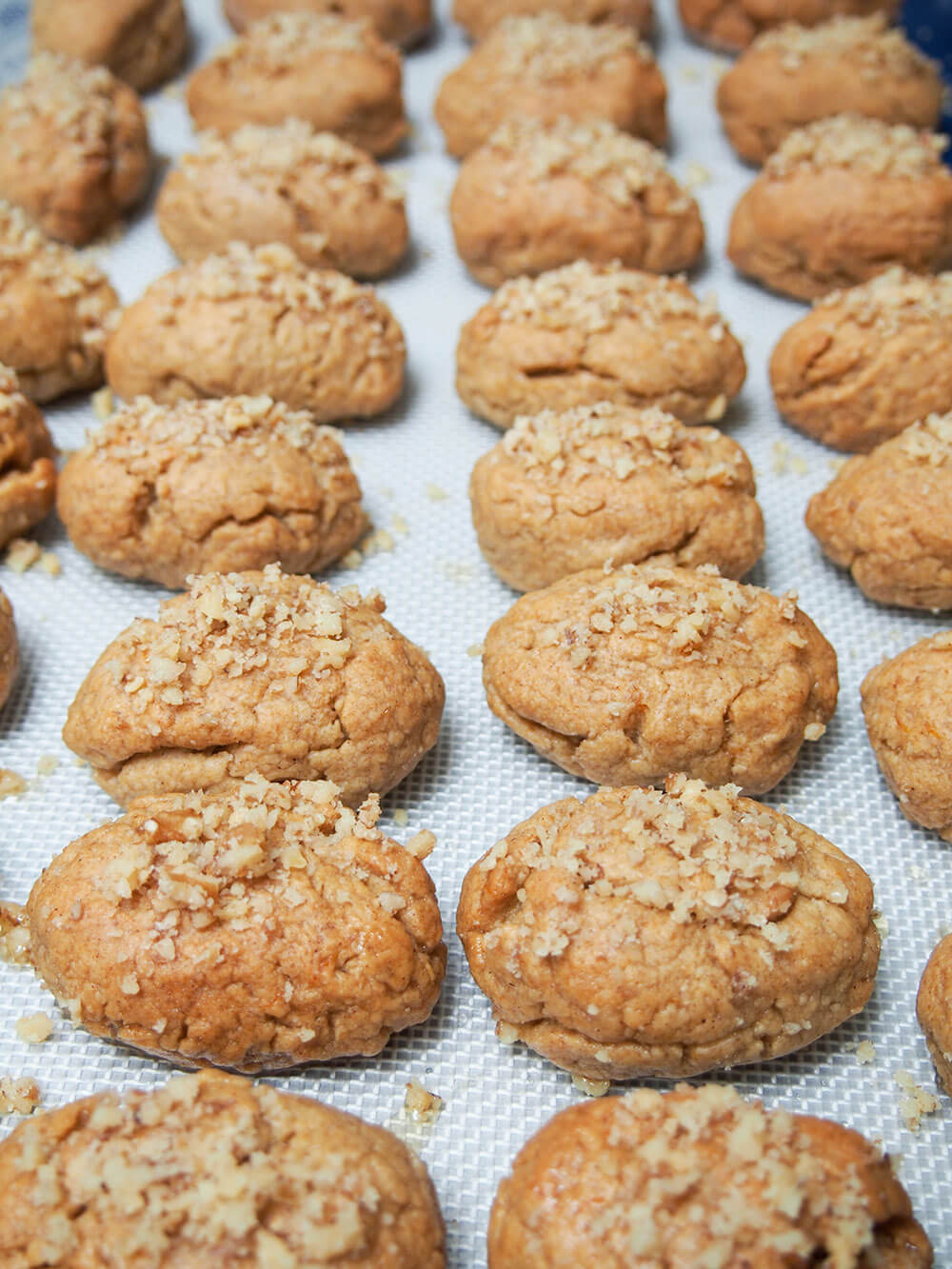 melomakarona (Greek honey cookies) drying on baking sheet Greek honey cookies drying on baking sheet