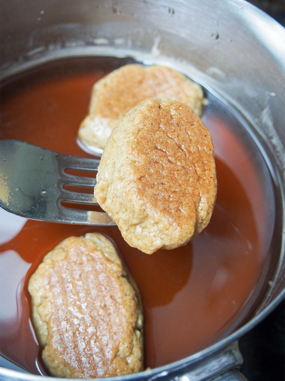 dipping melomakarona in honey syrup dipping melomakarona in honey syrup