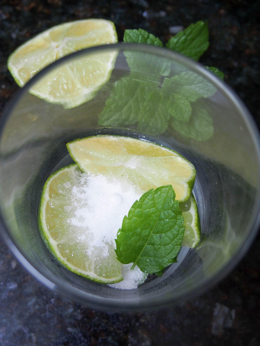 mint, lime and sugar in glass