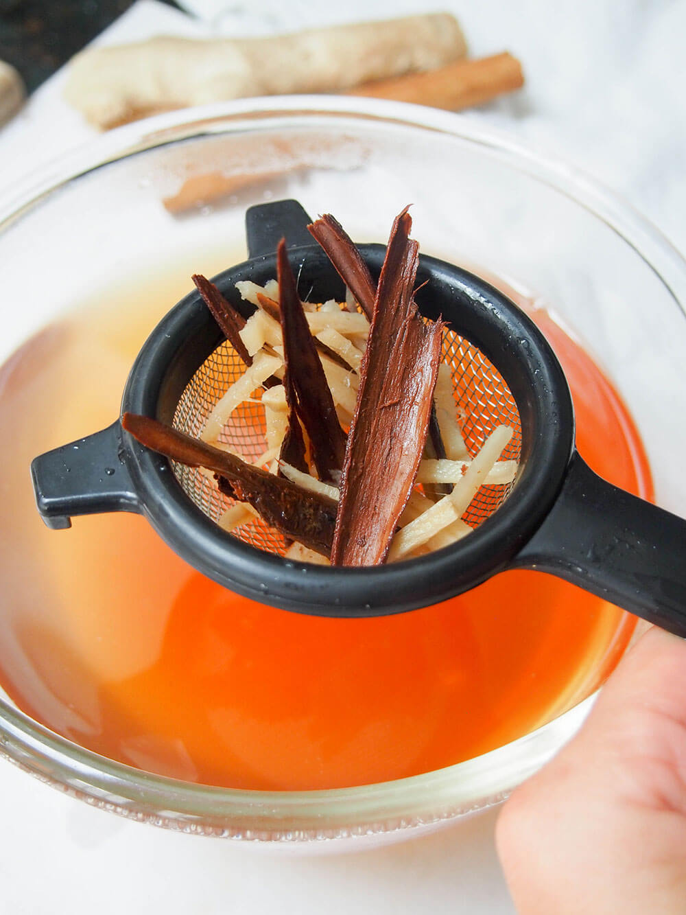straining spices from Korean cinnamon tea