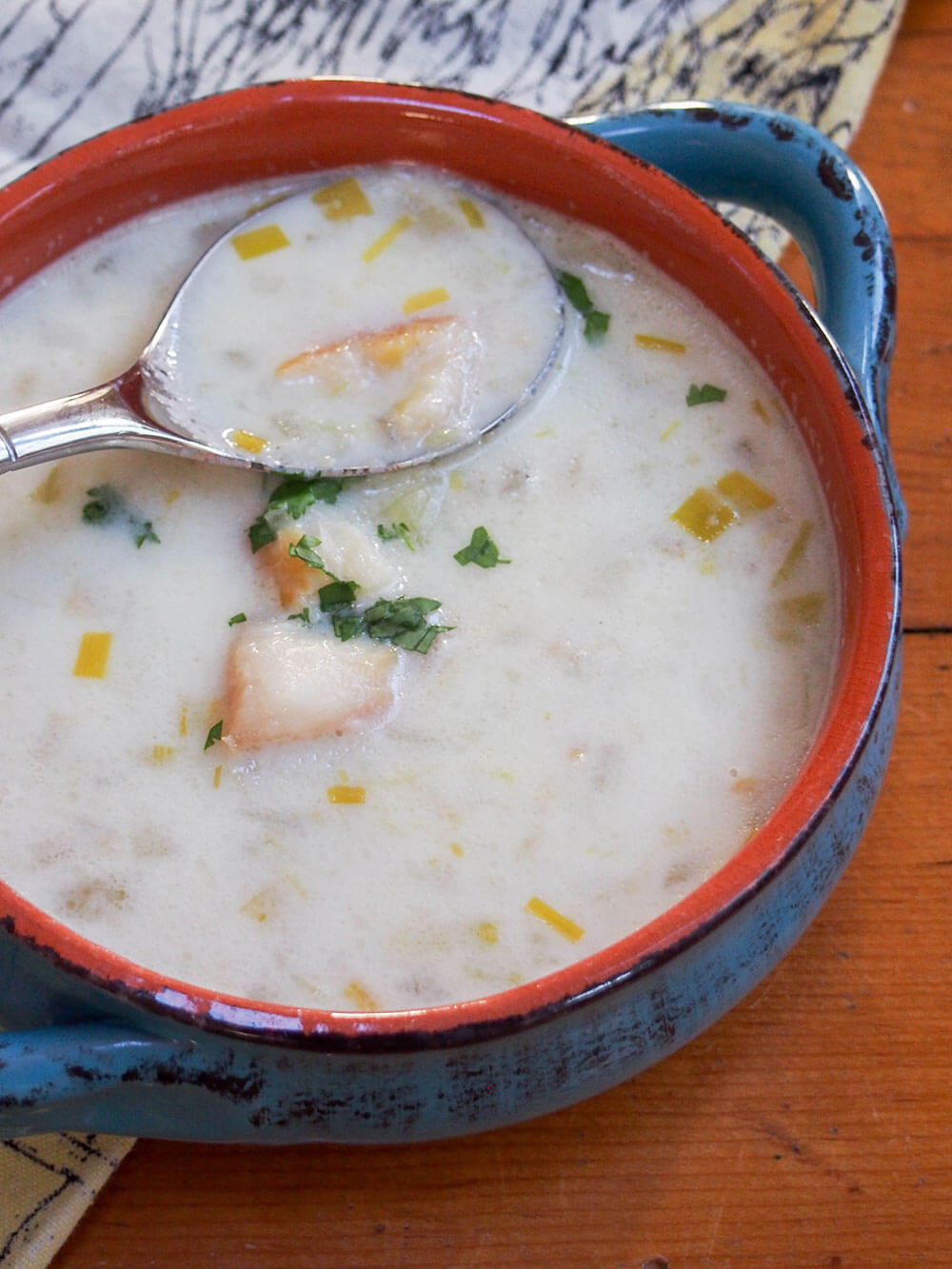 spoon in top of bowl of cullen skink - Scottish smoked haddock chowder