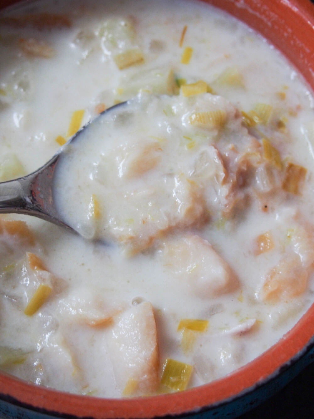 close up showing chunks of fish and potato in bowl of cullen skink