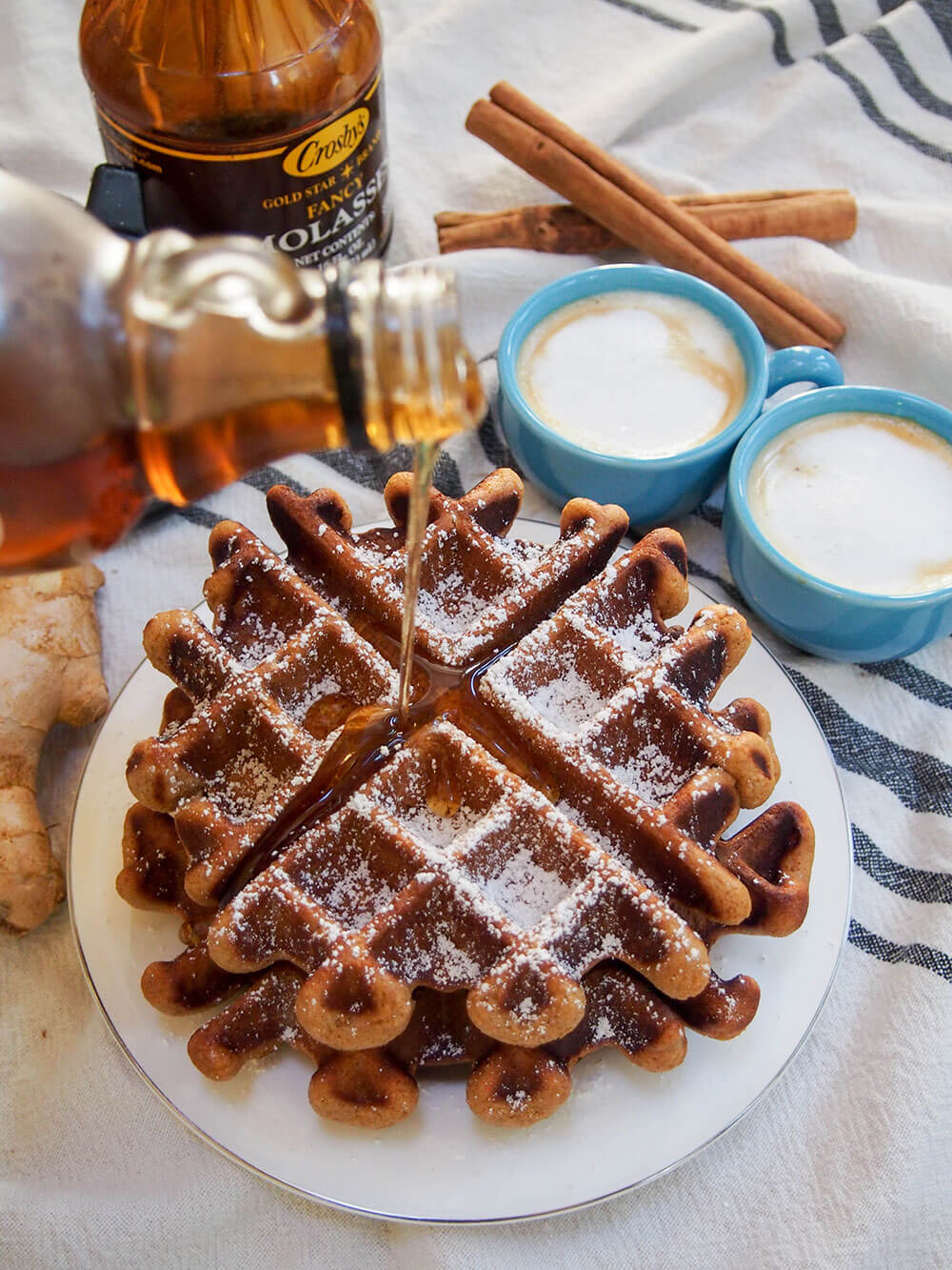 pouring syrup on gingerbread waffles