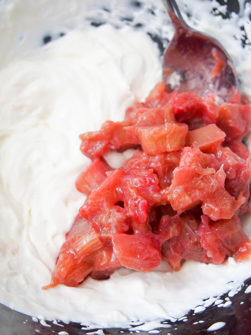 folding stewed rhubarb into whipped cream