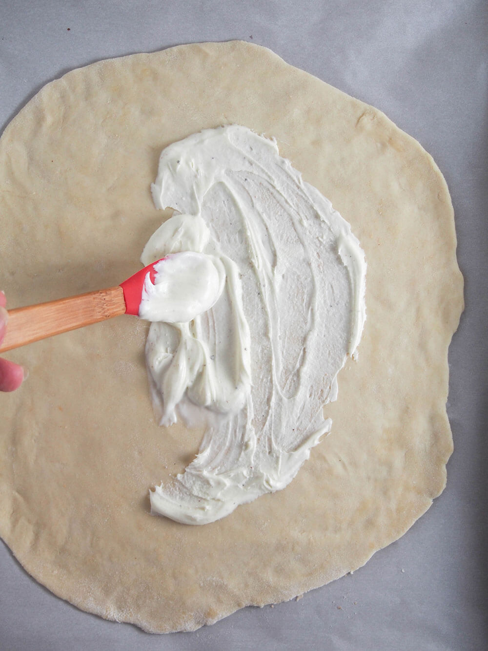 spreading creme fraiche on base