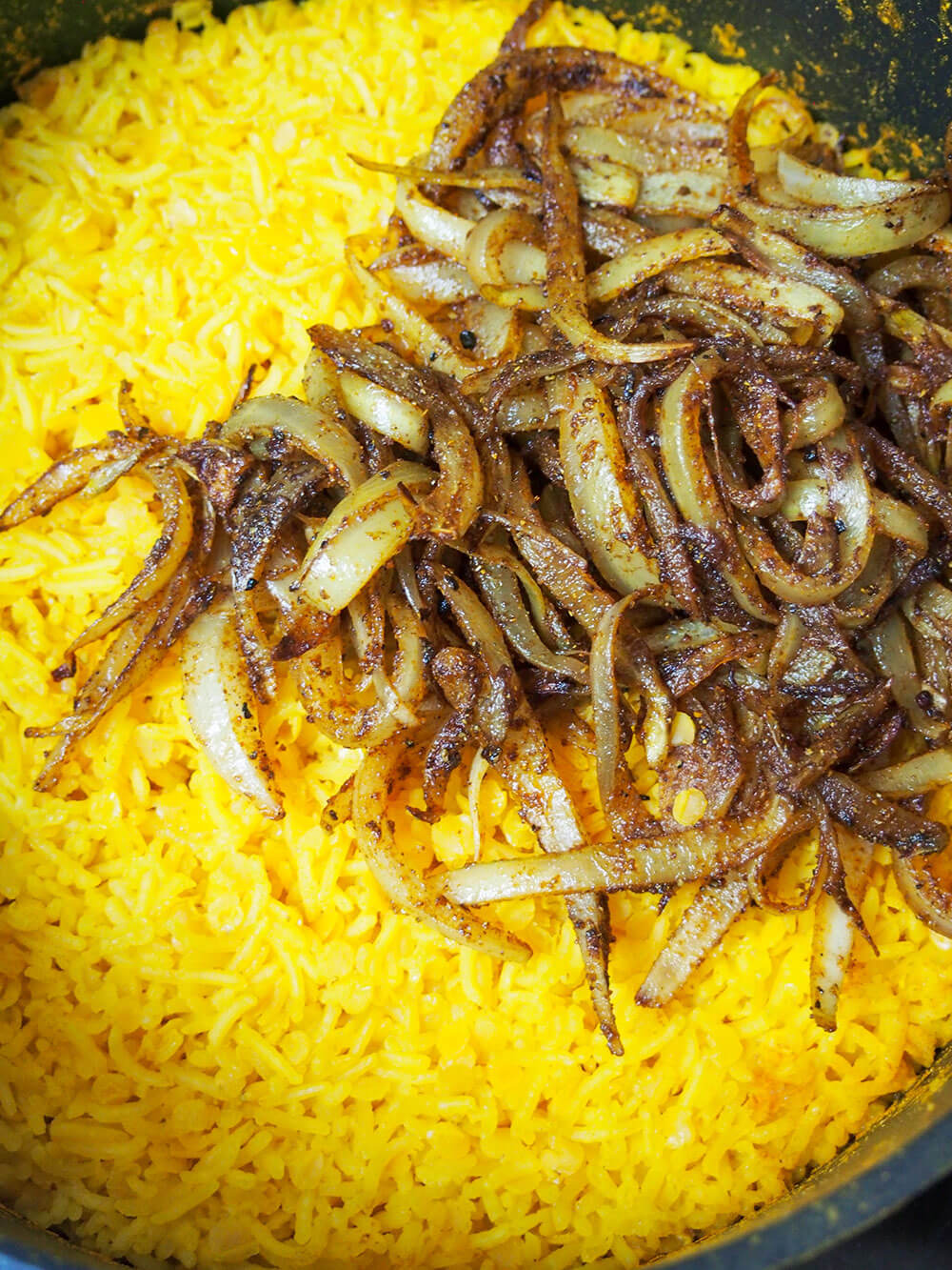 adding cooked onion to rice