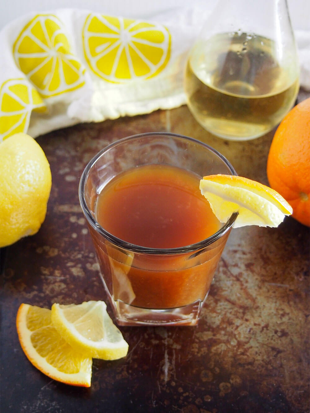 glass of finished cocktail with limoncello bottle behind