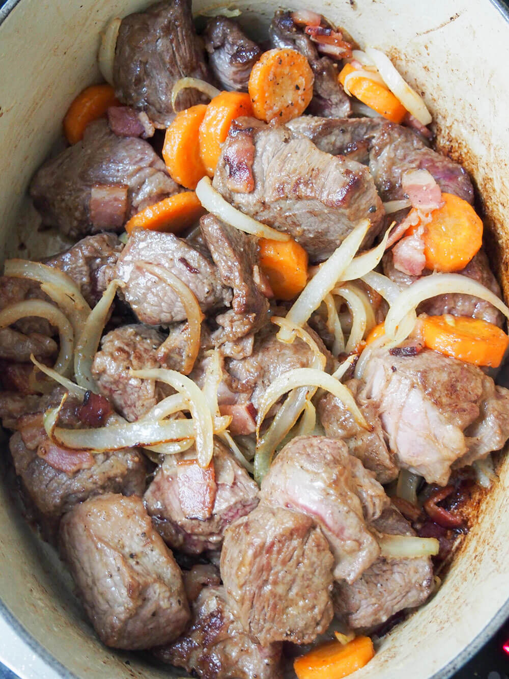 cooking beef and vegetables for beef bourguignon