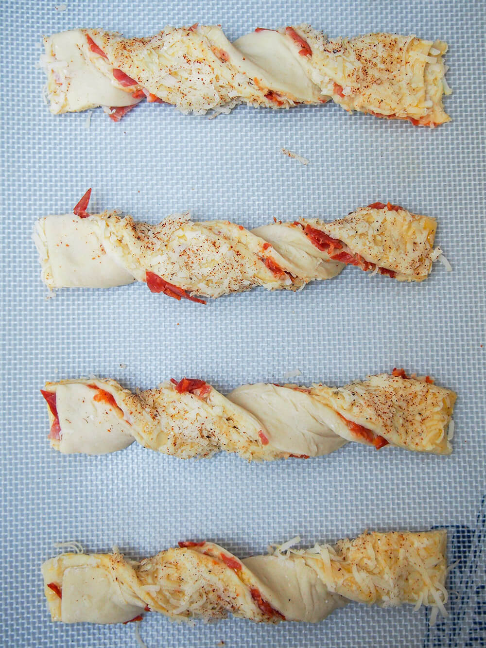 chorizo cheese twists on baking sheet ready to bake