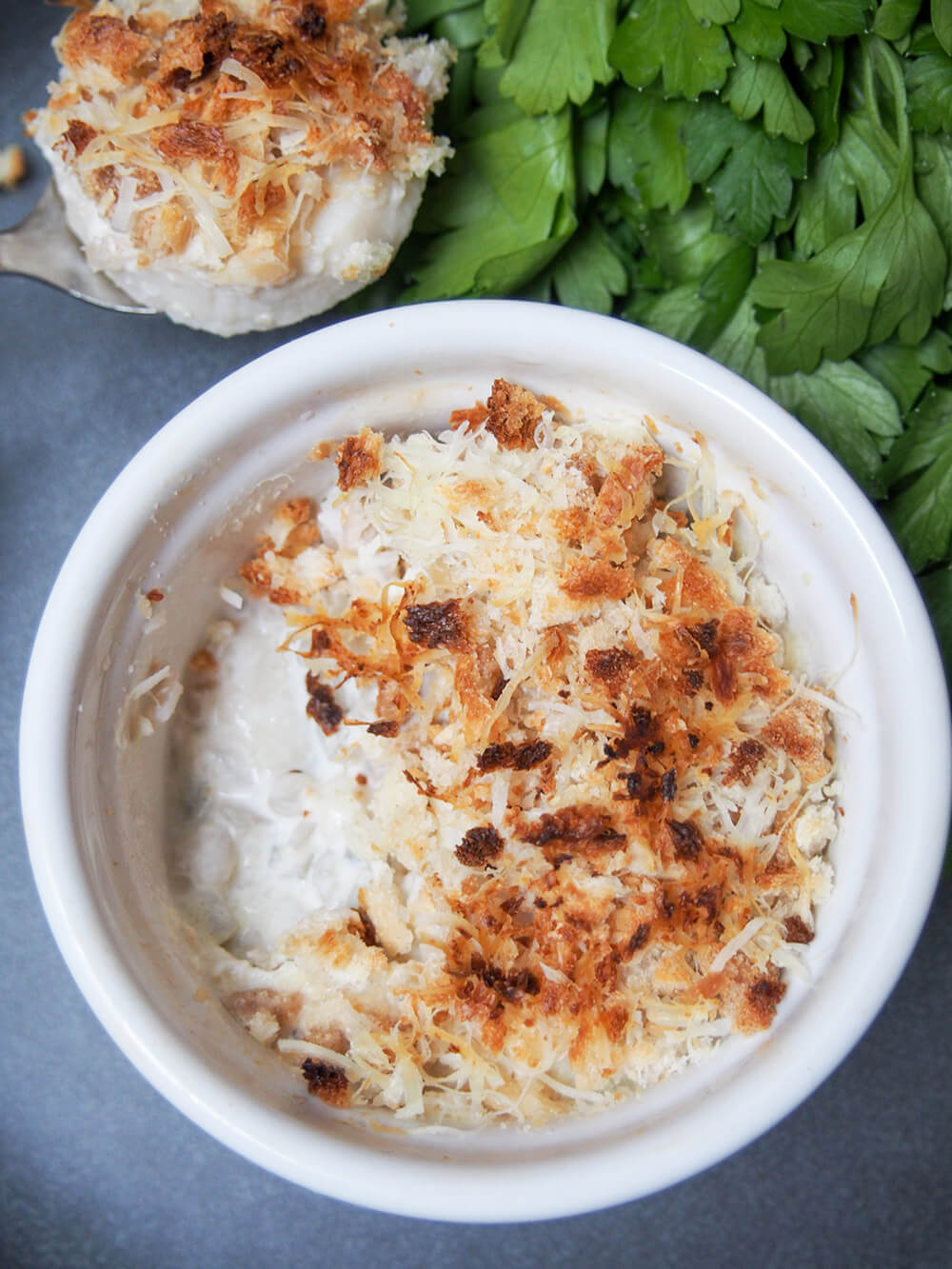 Coquille St Jacques is a scallop gratin with the scallops wrapped in a cream & wine sauce with a crisp topping. Make someone feel special and make it soon! Coquille St Jacques (scallop gratin) with spoonful taken from dish