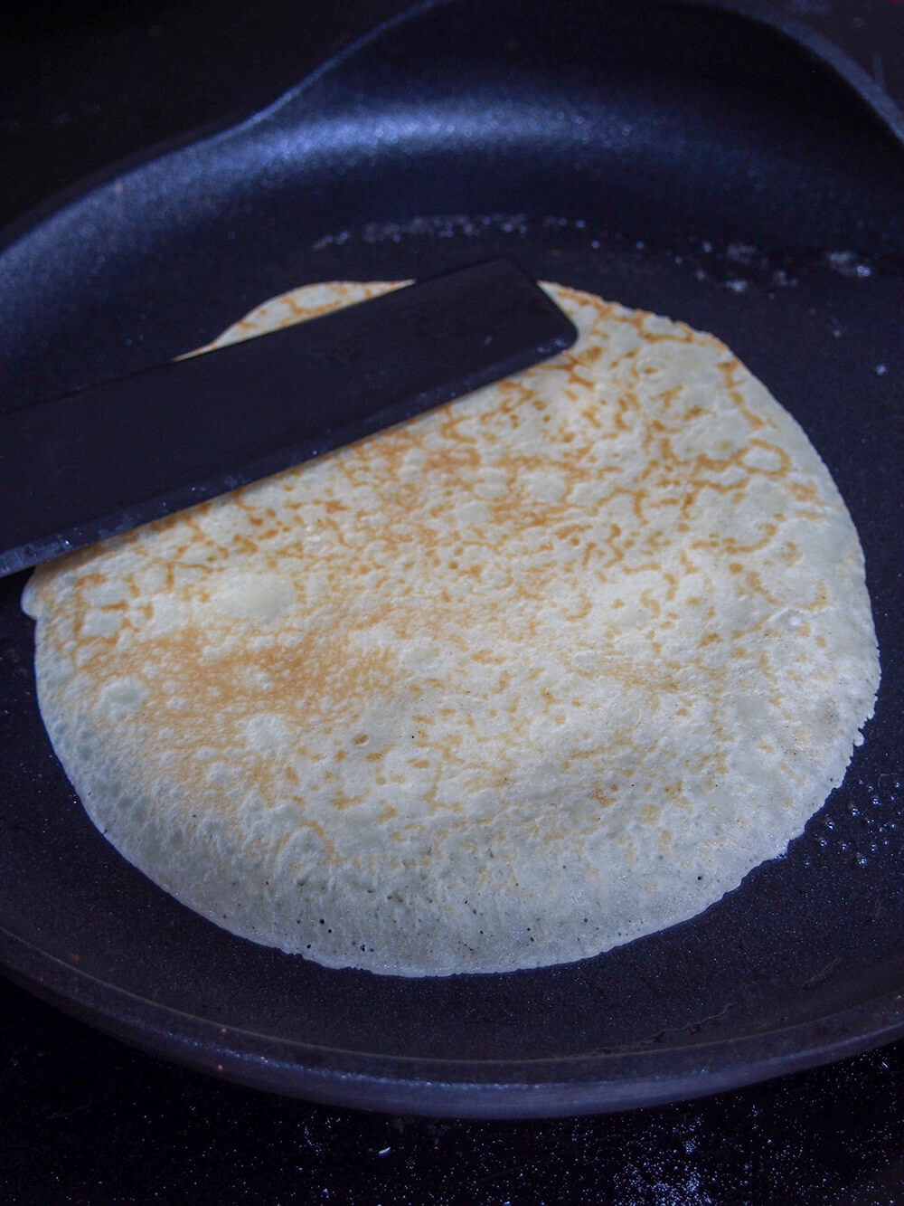 flipped over pancake in crepe pan