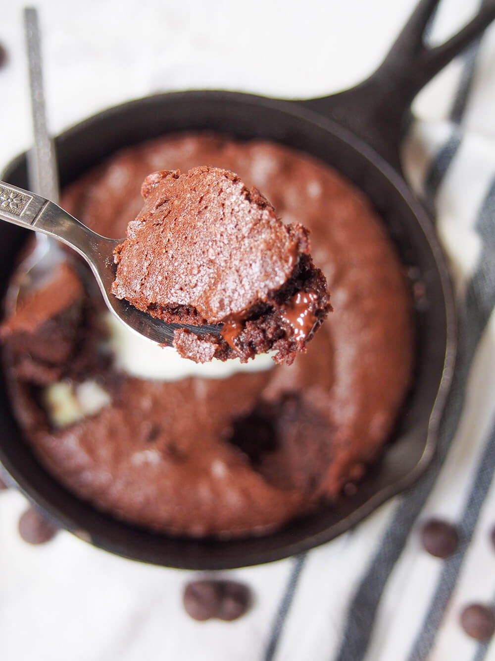 spoonful held over skillet with rest of brownie