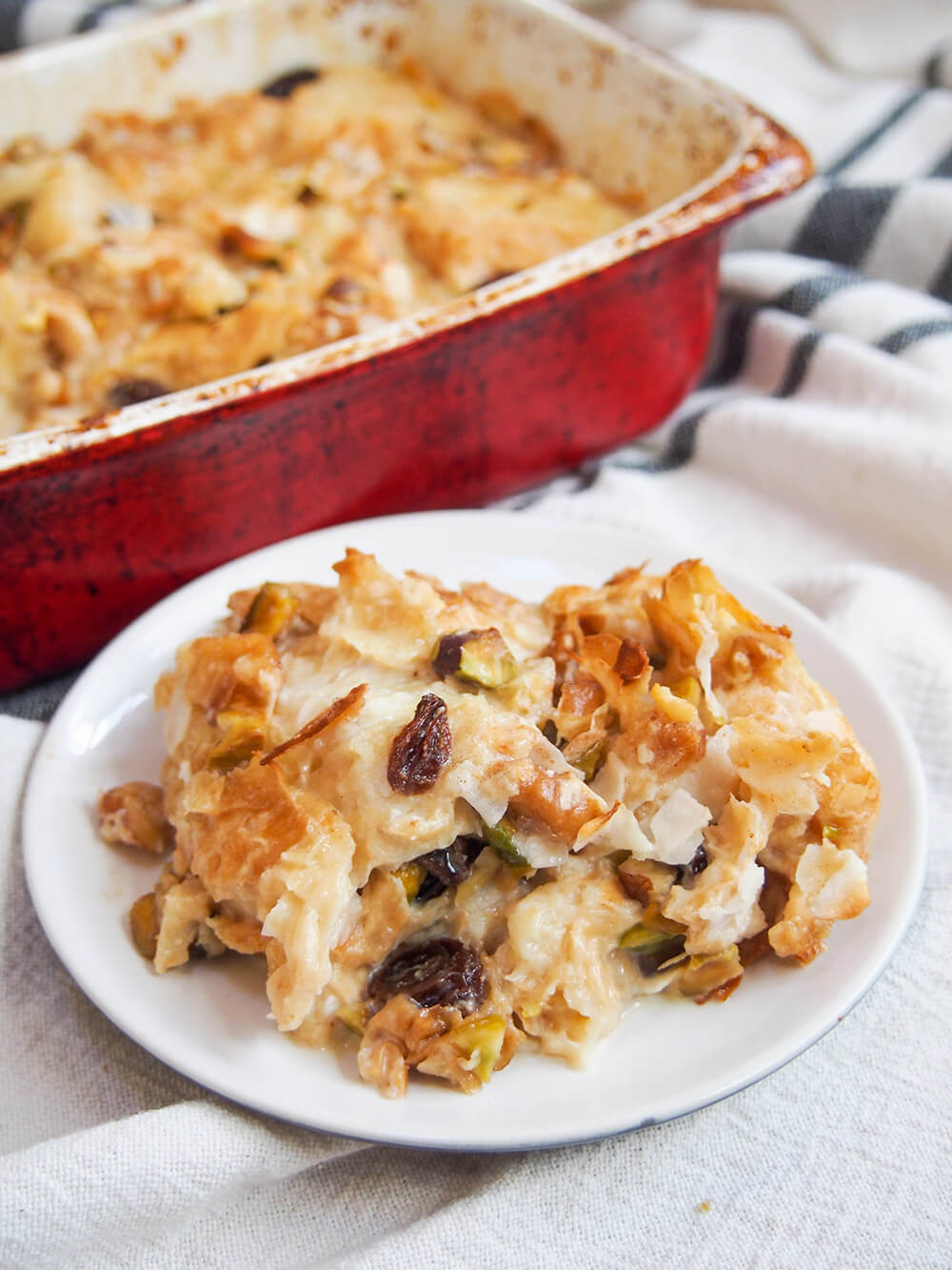 umm Ali Egyptian bread pudding on plate with rest in dish behind