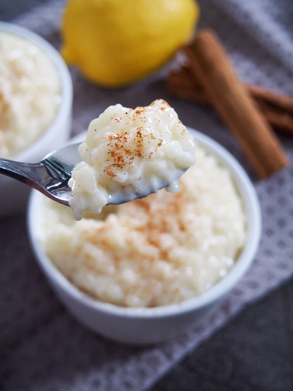 taking spoonful of arroz con leche from bowl