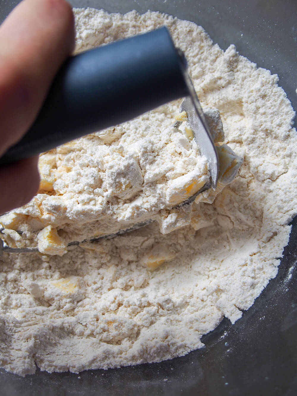 cutting butter into dry ingredients for coconut mango scones