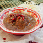 bowl of Fesenjan (Persian walnut pomegranate stew with chicken)