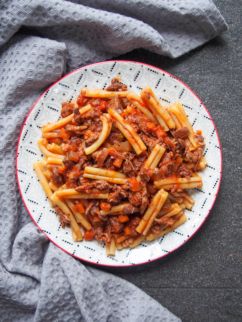 plate of lamb ragu pasta viewed from overhead