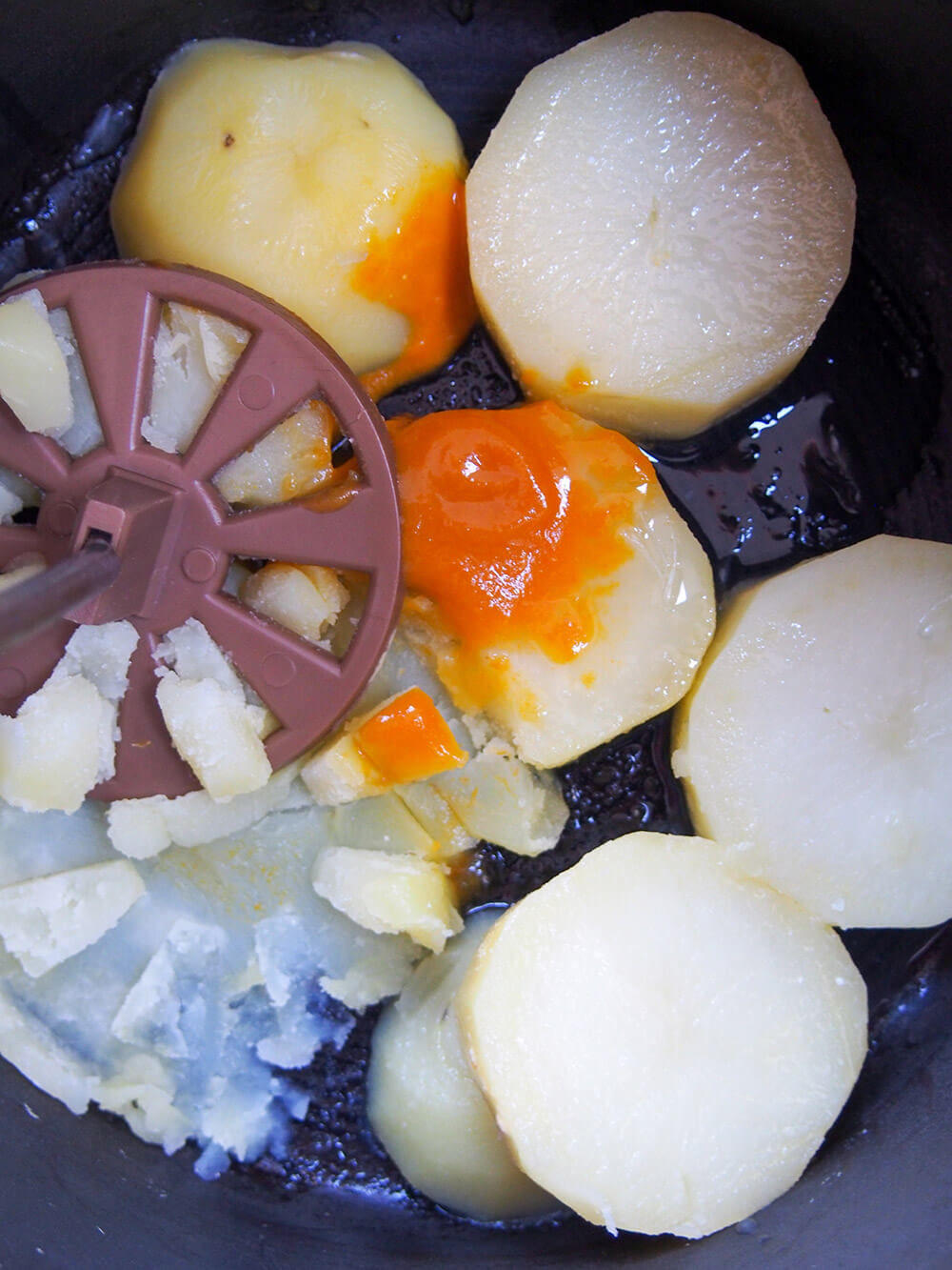 mashing potatoes with lime and aji amarillo