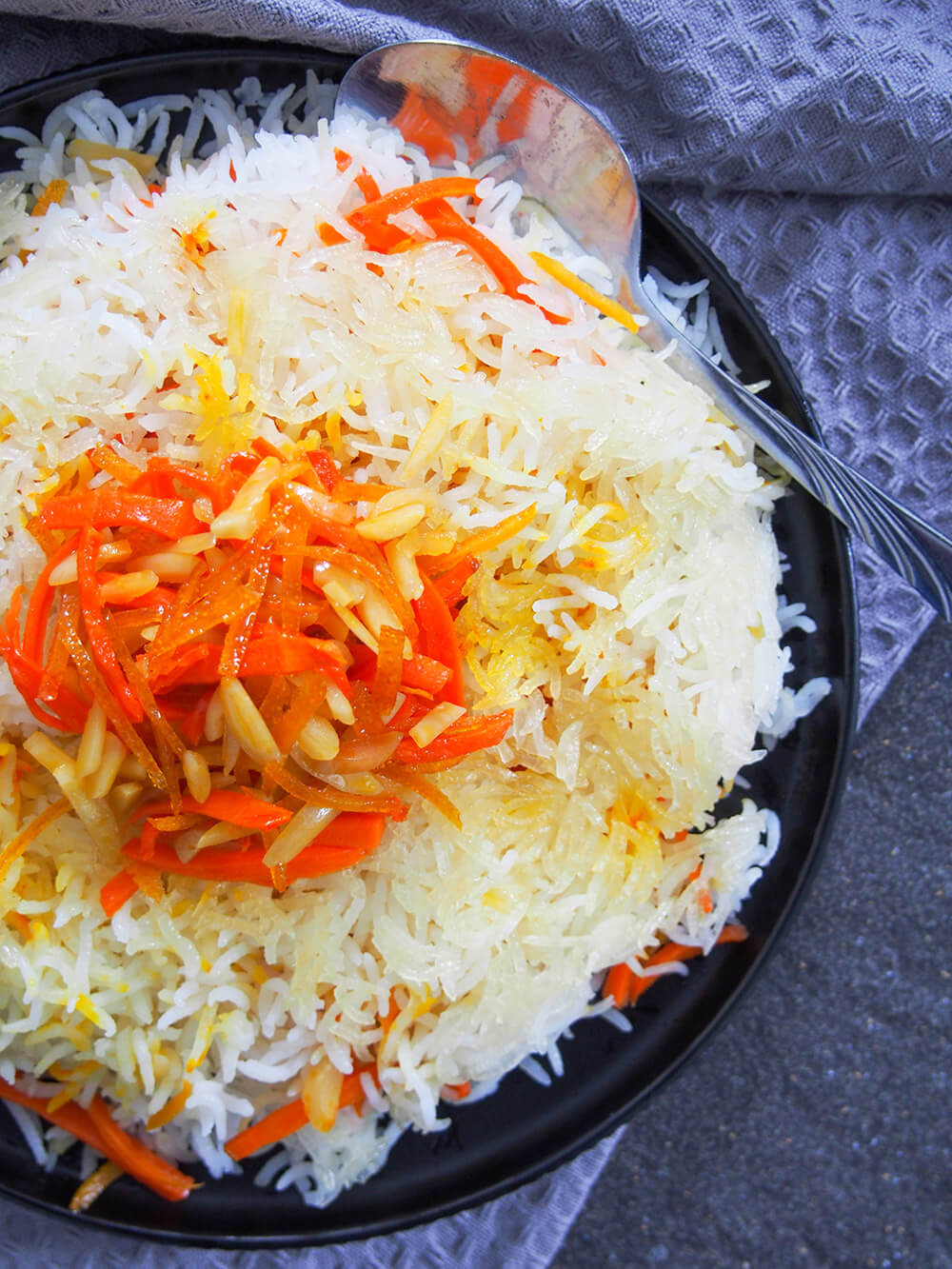 Persian sweet rice (shirin polow) plate from overhead with spoon on side of plate