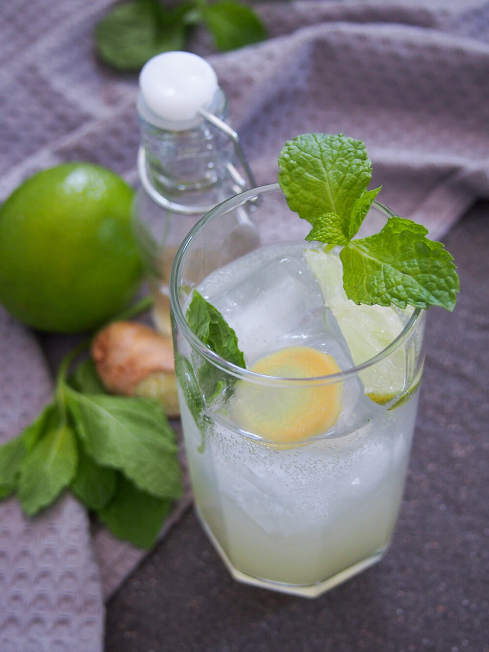 glass of finished cocktail topped with mint garnish