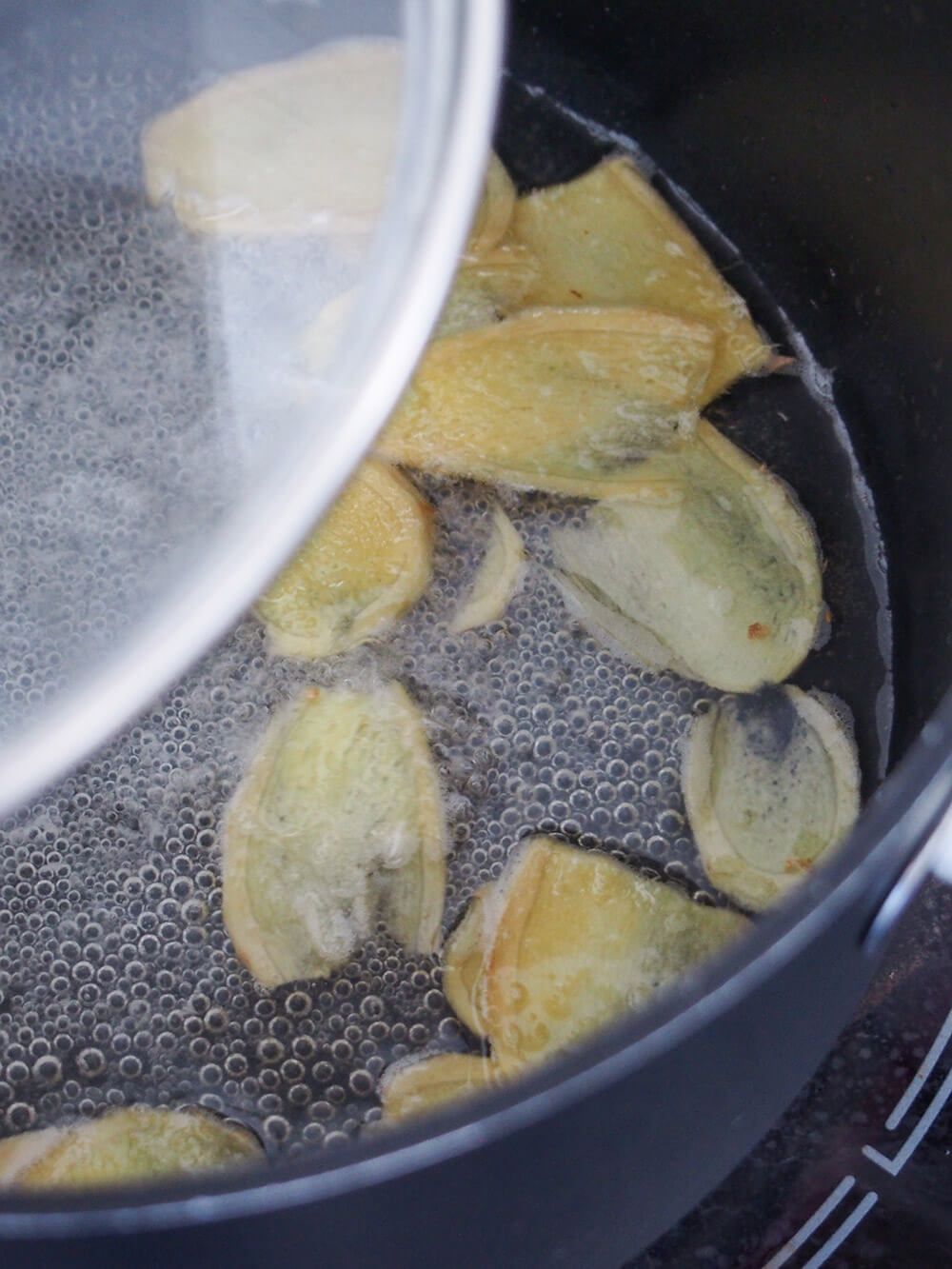 simmering slices of ginger with water and sugar