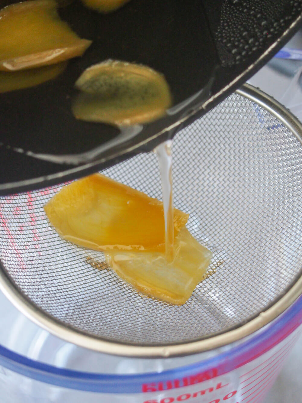 straining ginger from syrup