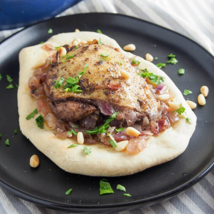 Musakhan (Palestinian sumac chicken) served on bread on a plate