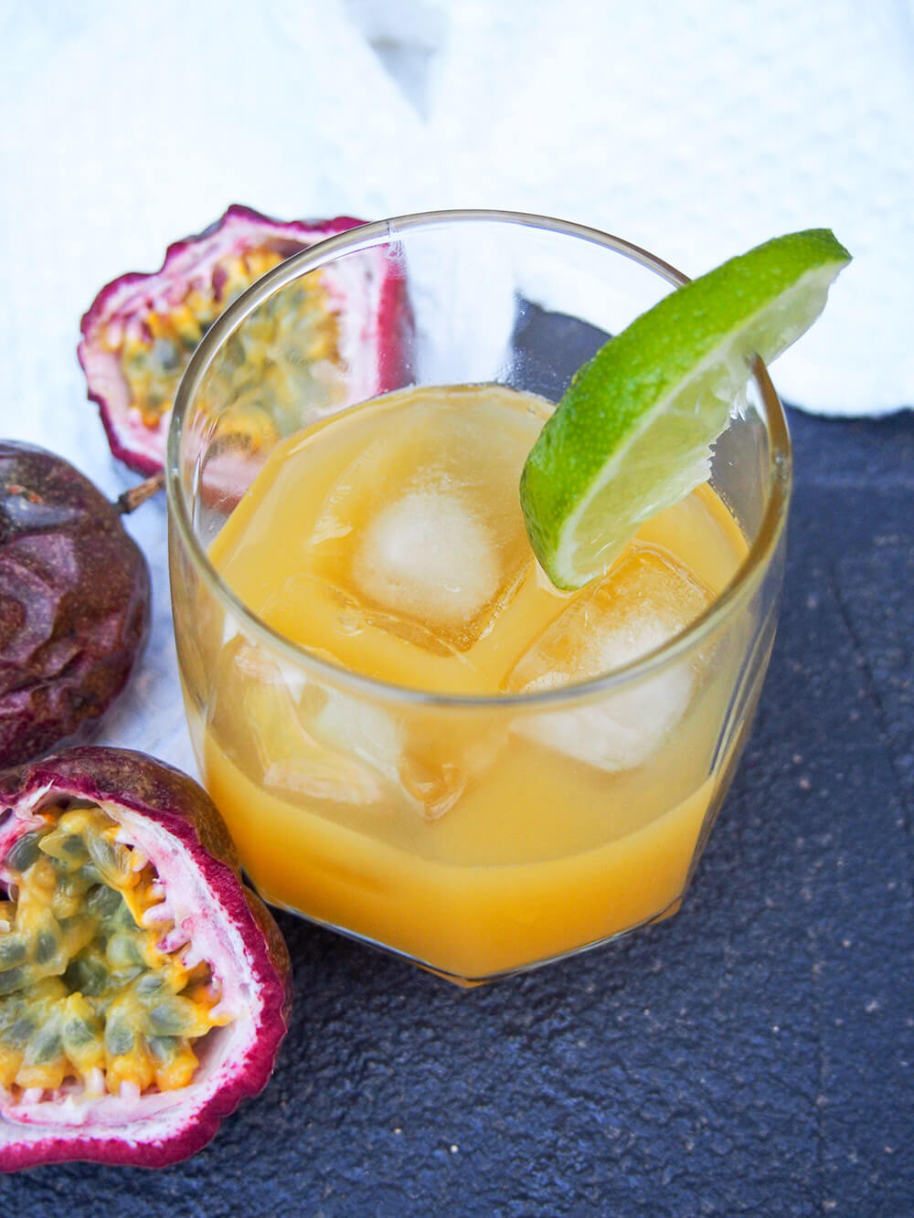 passion fruit margarita with plenty ice and lime garnish