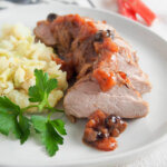 pork tenderloin with rhubarb chutney on plate with mash to side