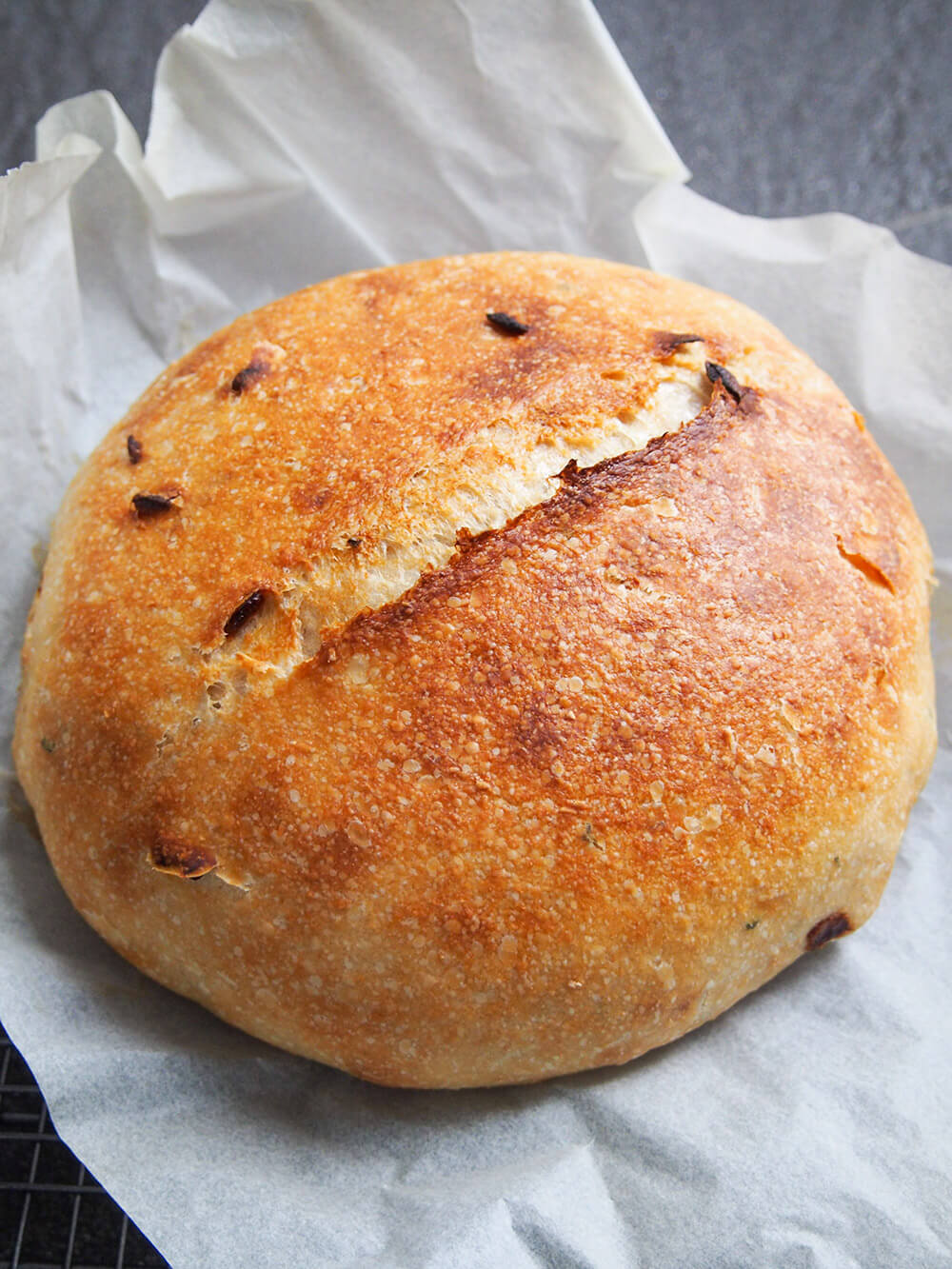 cooling loaf of sage and caramelized onion sourdough bread