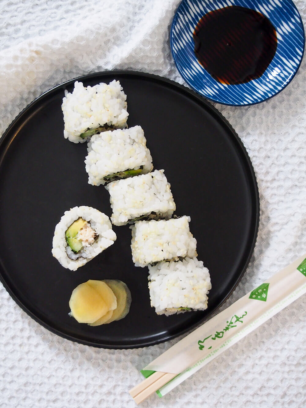 cut California roll on plate from above