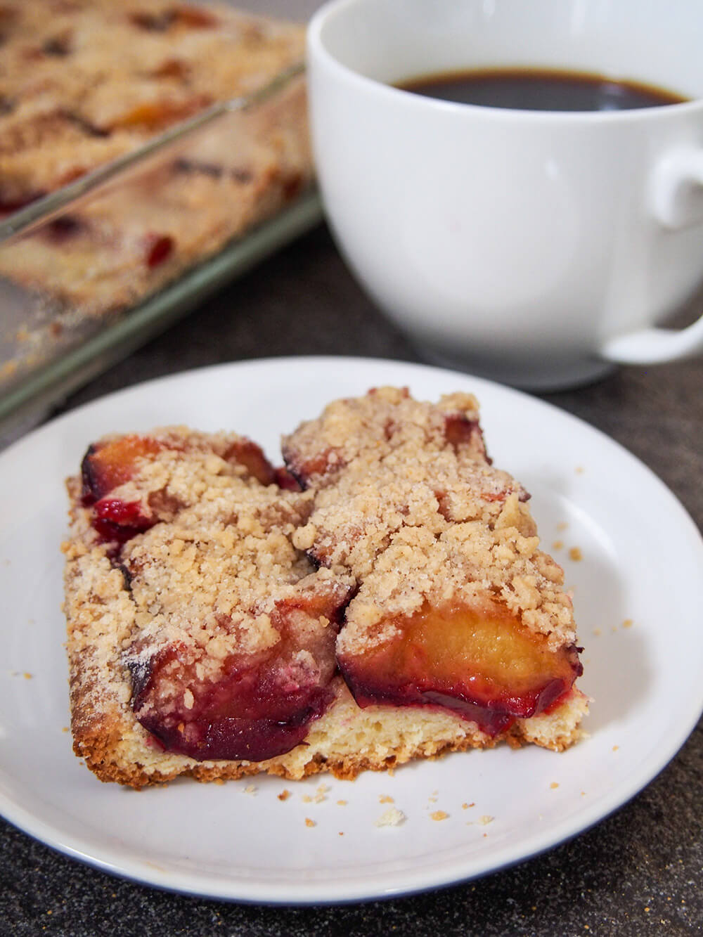 slice of German plum cake (pflaumenkuchen) on plate
