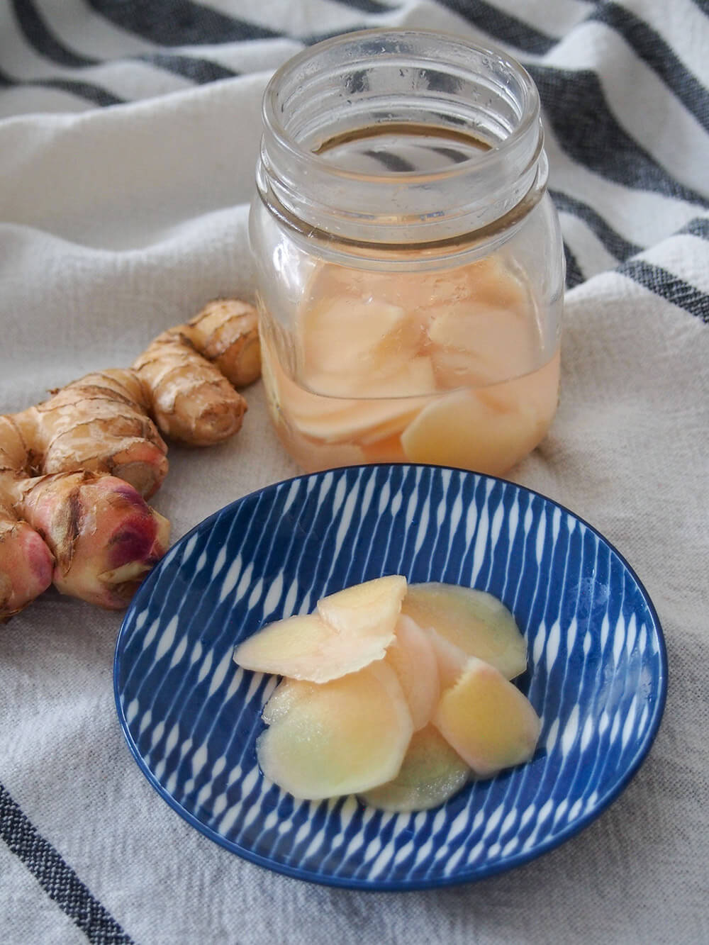 Japanese pickled ginger with some on plate and more in jar behind