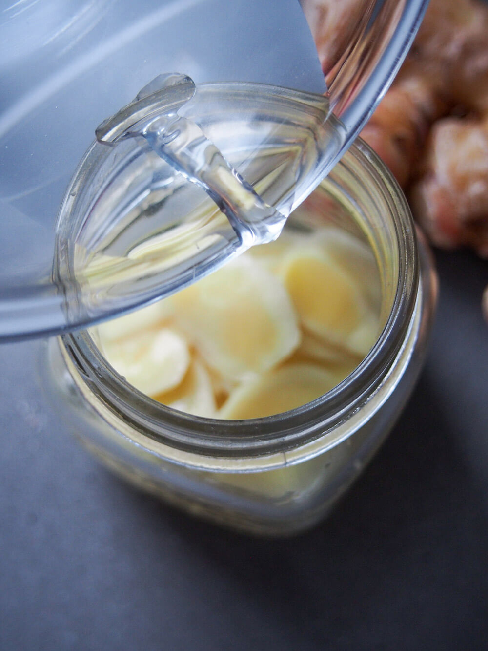 adding pickling liquid to jar