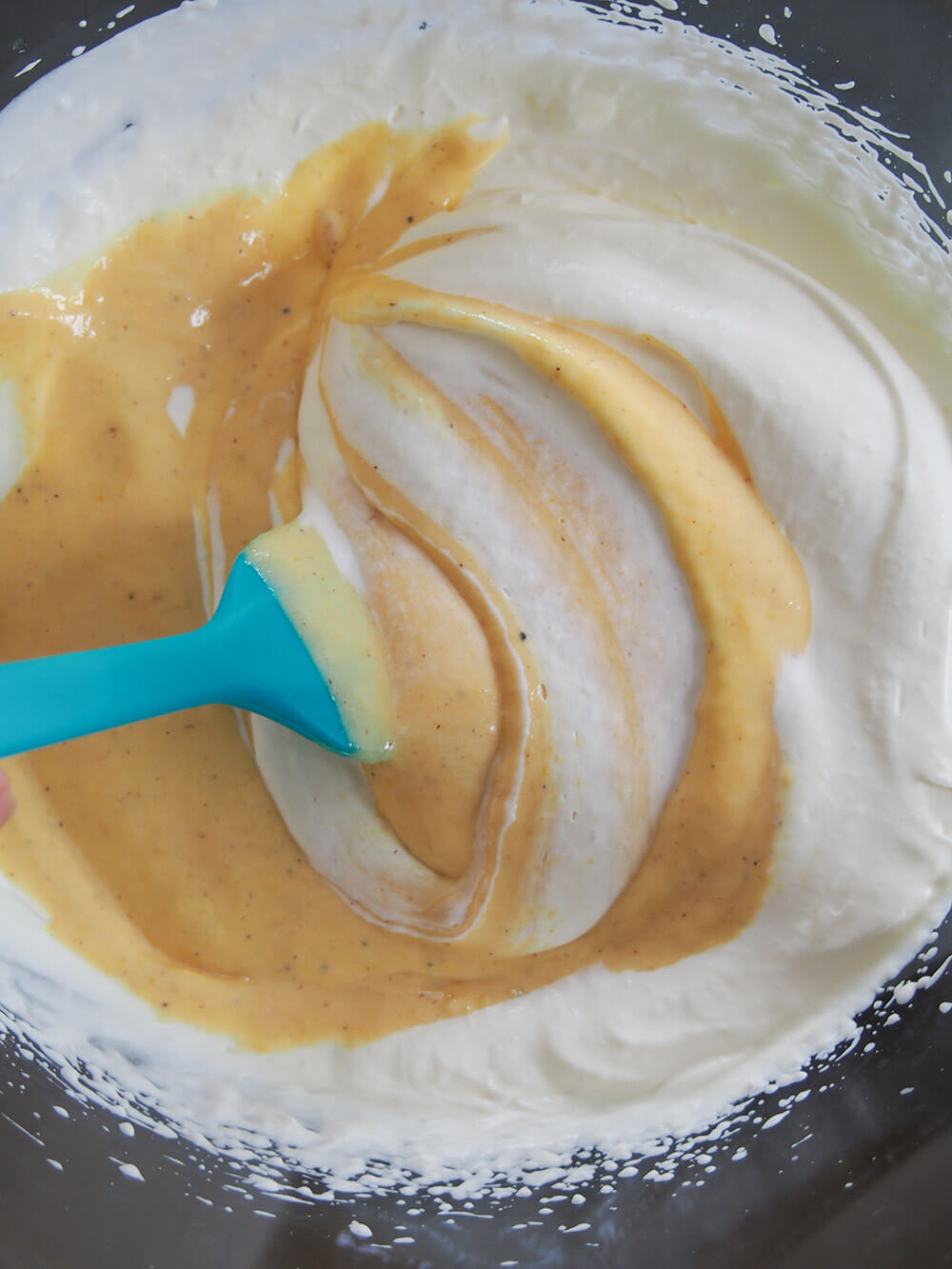 folding passion fruit mixture into cream