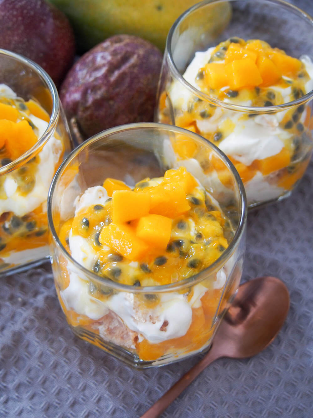 mango passion fruit Eton mess in serving glass showing fruit on top